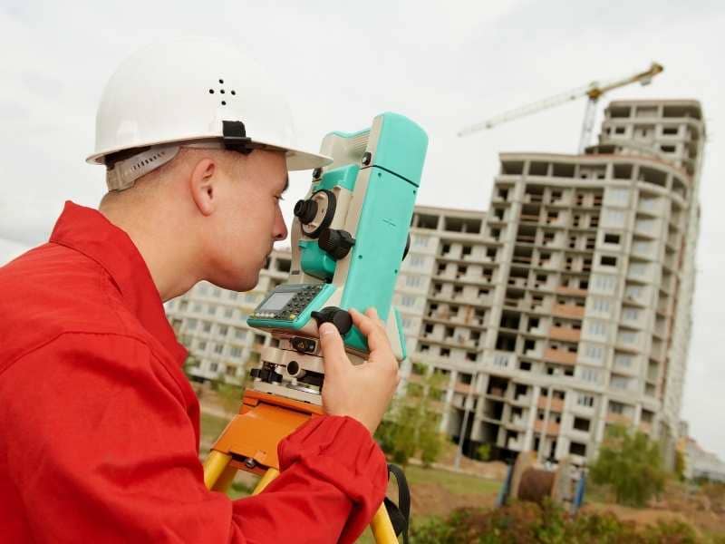 Surveyor completing an ALTA title survey for commercial property refinancing in Philadelphia Pennsylvania
